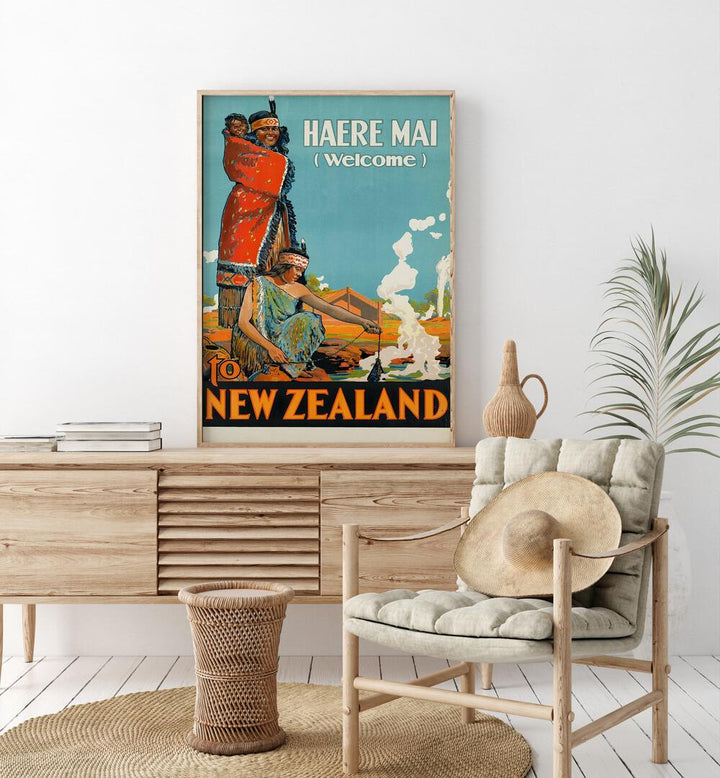 Haere Mai Welcome-to New Zealand  Travel Posters in Oak Wood Plain Frame placed on a console table behind a chair