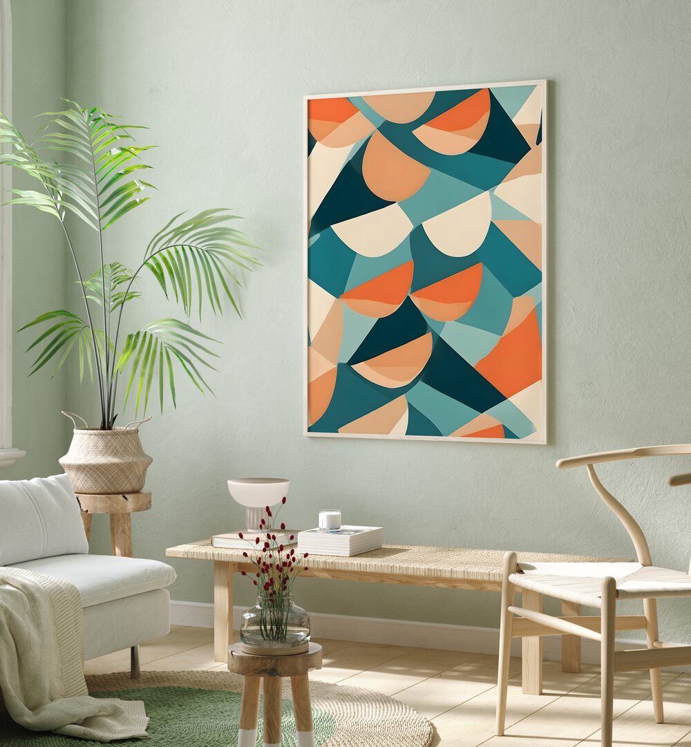 Half Cut By Uma Gokhale Abstract Art Print in Oak Wood Plain Frame above a table on a green wall beside a plant