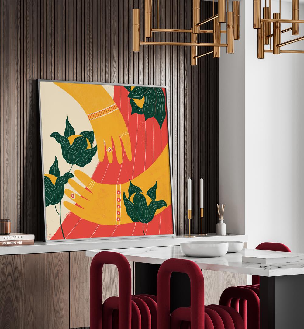 Hands by Shriya Bhattacharya Art Prints in Black Plain Frame on a console table behind a dining table