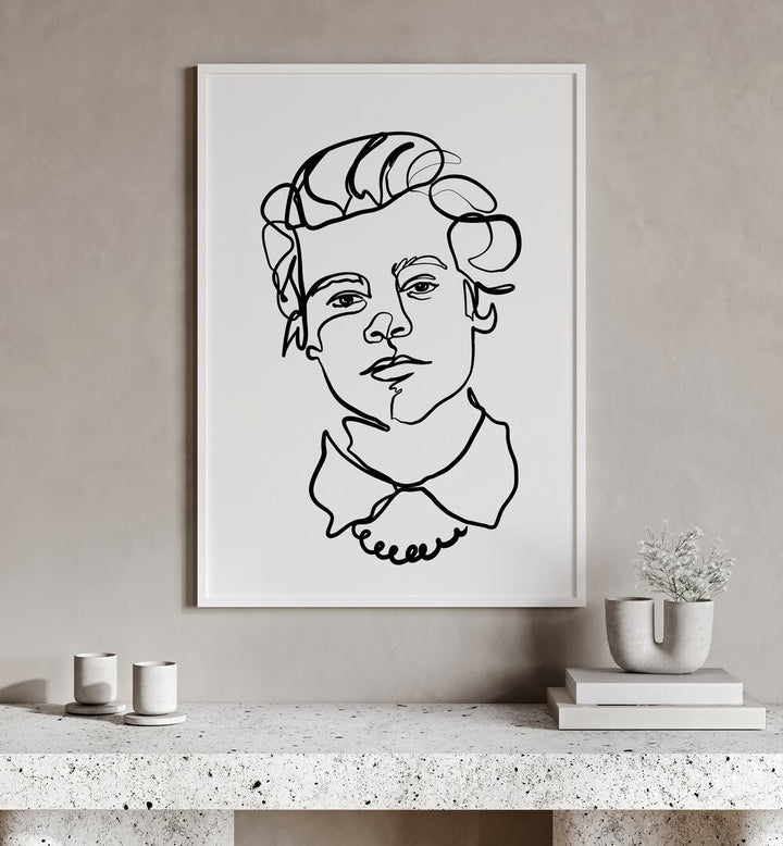 Harry Styles by Hanna Lee Tidd Line Art Paintings Line Art Prints in White Plain Frame placed on a wall behind a table