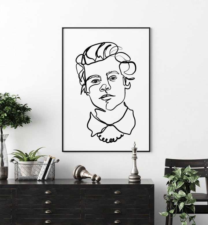 Harry Styles by Hanna Lee Tidd Line Art Paintings Line Art Prints in Black Plain Frame placed on a wall behind a table