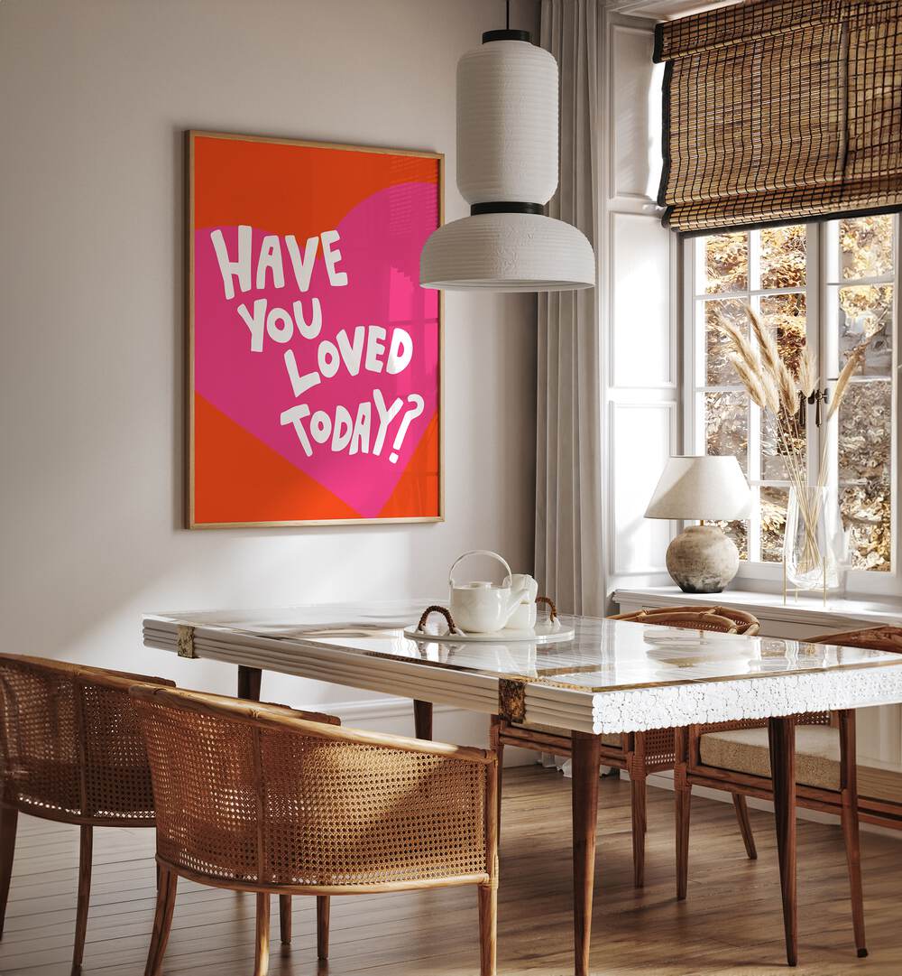 Have You Loved Today by Athene Fritsch Quotes and Typography Posters in Oak Wood Plain Frame placed on a wall in a dining room area beside a window and behind a dining table