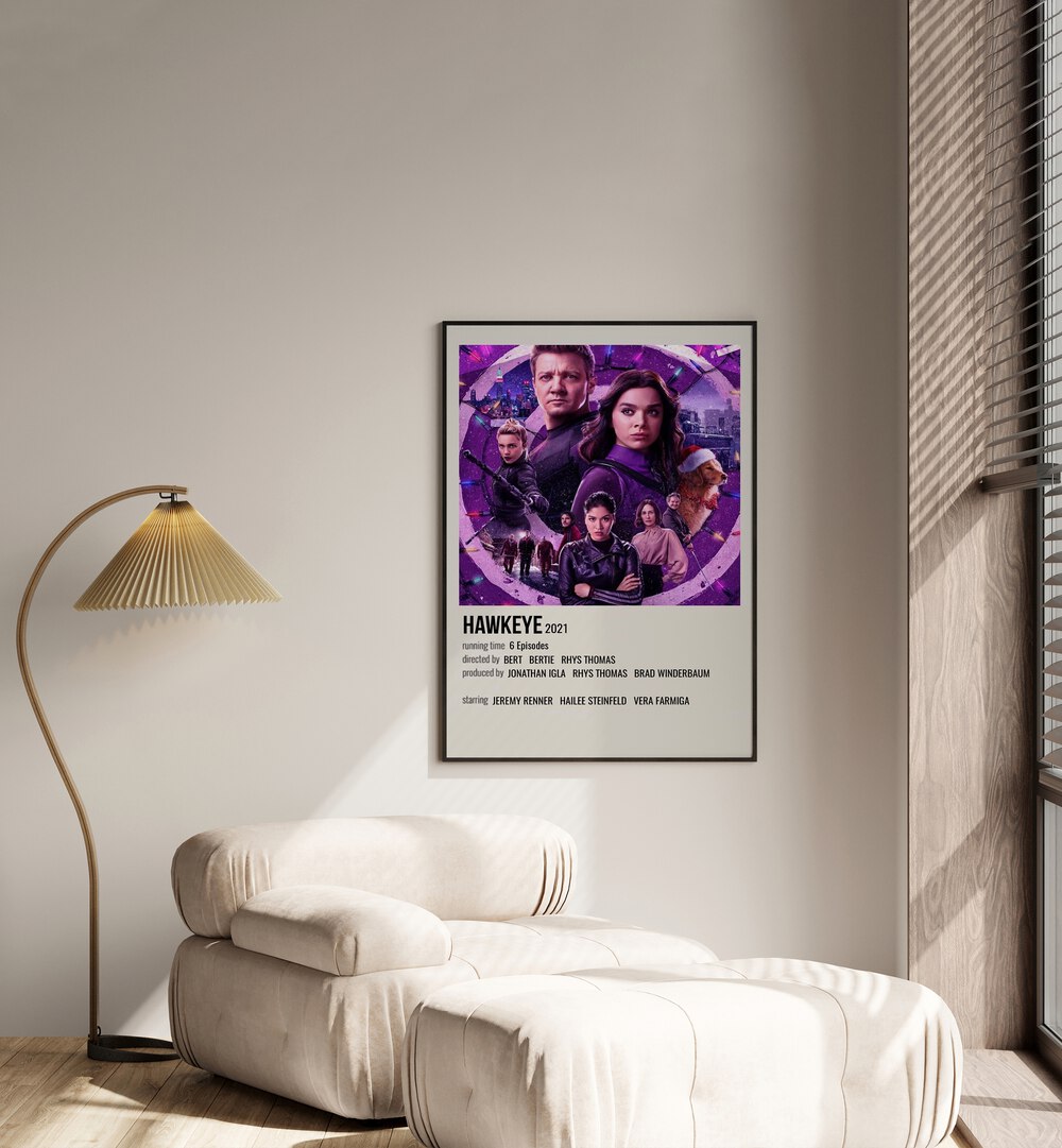 Hawkeye Movie Posters in Black Plain Frame placed on a white wall beside a window and behind a sofa