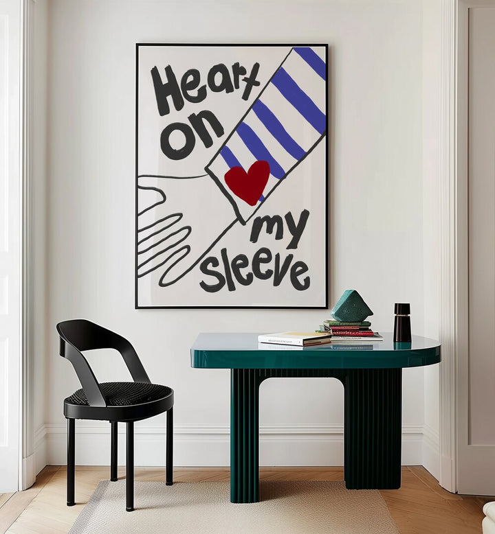 Heart on My Sleeve by Athene Fritsch Quotes and Typography Posters in Black Plain Frame placed on a wall behind a study table