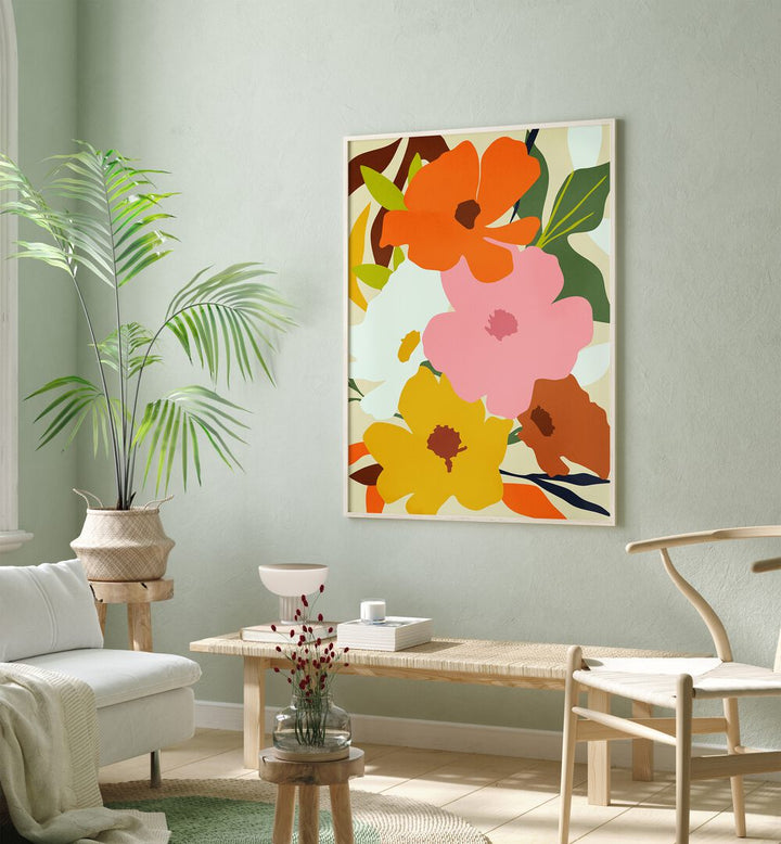 Hello Spring By Uma Gokhale Botanical Art Prints in Oak Wood Plain Frame on a wall above a table beside a plant