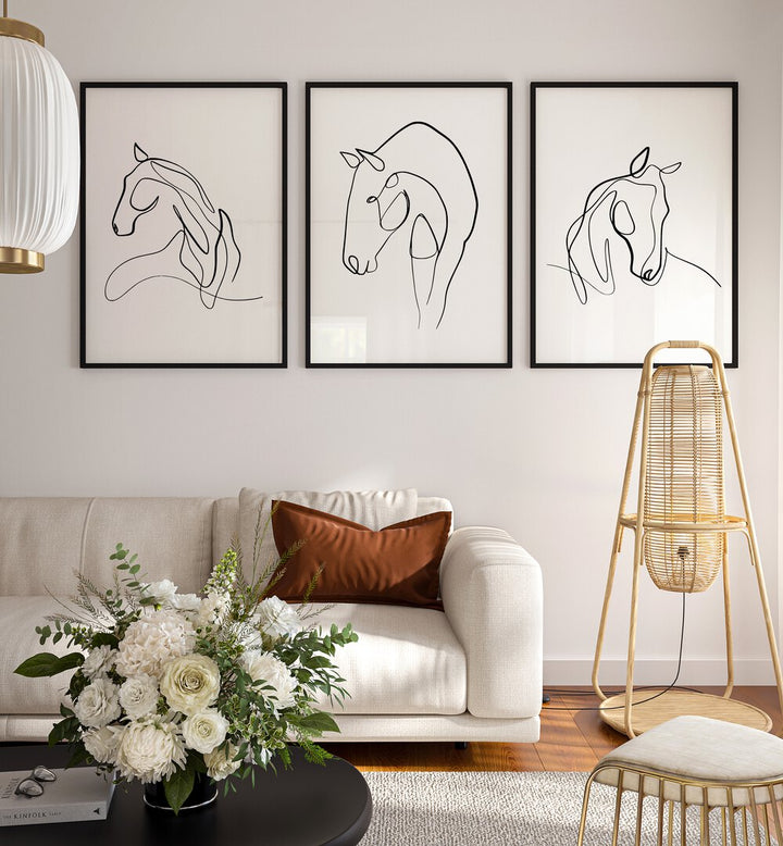 Horses Line Art Set Set Of 3 Paintings in Black Plain Frame placed on a wall behind a sofa for living room