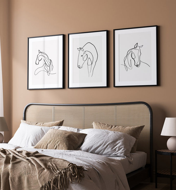 Horses Line Art Set Set Of 3 Paintings in Black Plain Frame placed on a wall behind  a bed  for bedroom