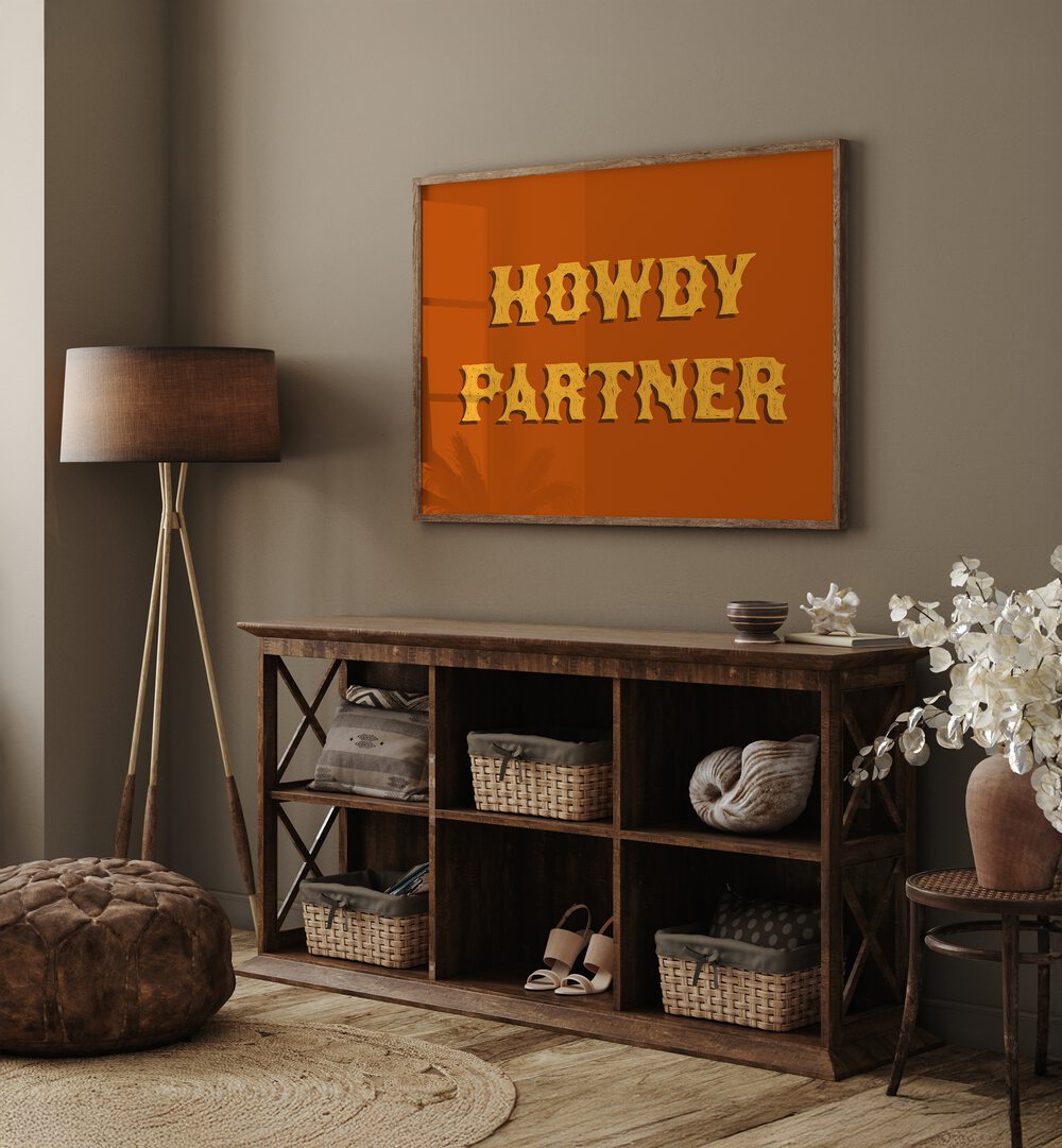 Howdy Partner Quotes And Typography Posters in Oak Wood Plain Frame placed on a Grey Colored Wall above a Console Table in the Drawing Room 