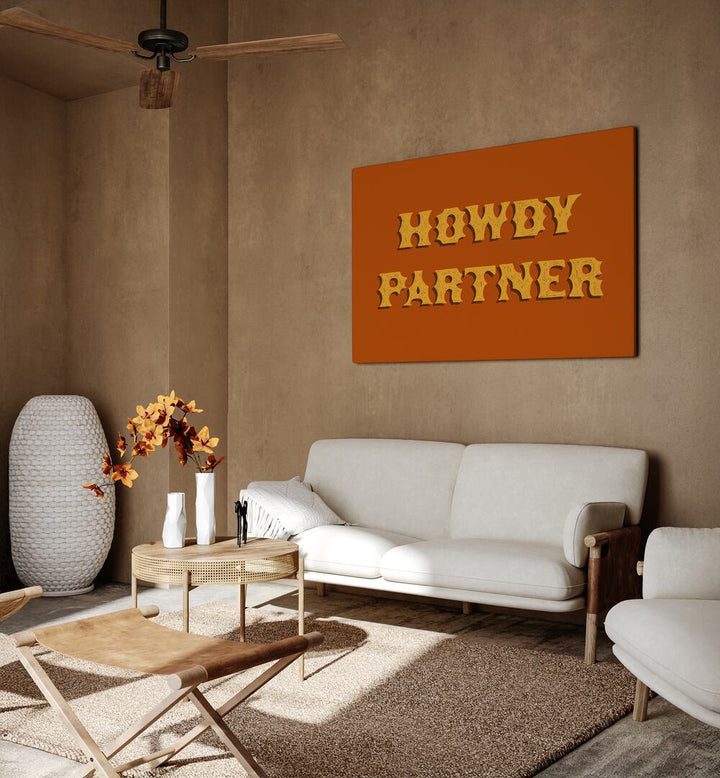 Howdy Partner Quotes And Typography Posters in Gallery Wrap placed on a Dessert Brown Colored Wall near a White Sofa in the Living Room