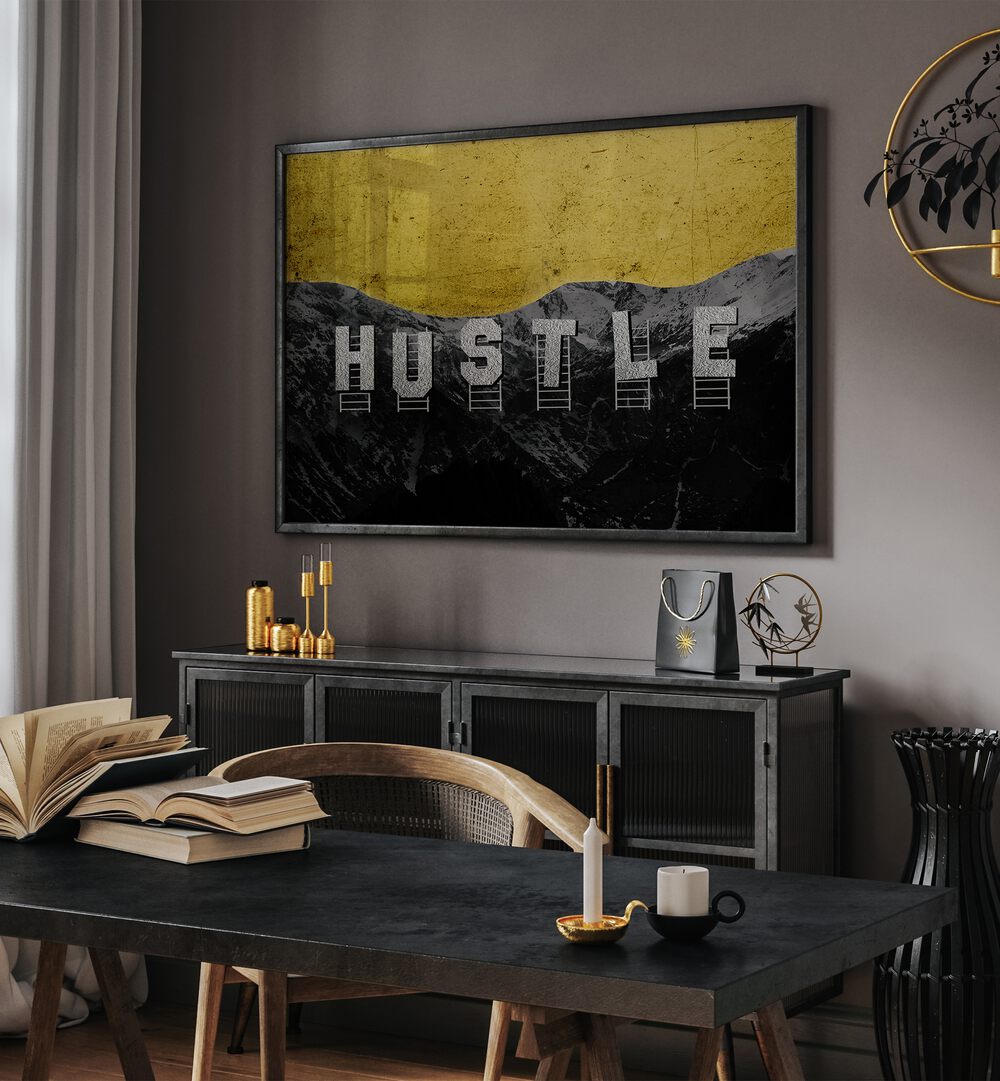 Hustle Hills Quotes And Typography Posters in Black Plain Frame placed on a Dark Grey Colored Wall above a Console Table in the Drawing Room