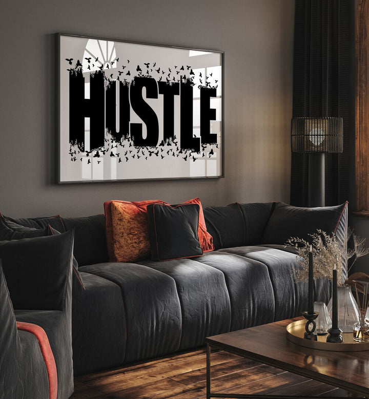 Hustle for Freedom Quotes and Typography Posters in Black Plain Frame placed in a living room wall behind a sofa