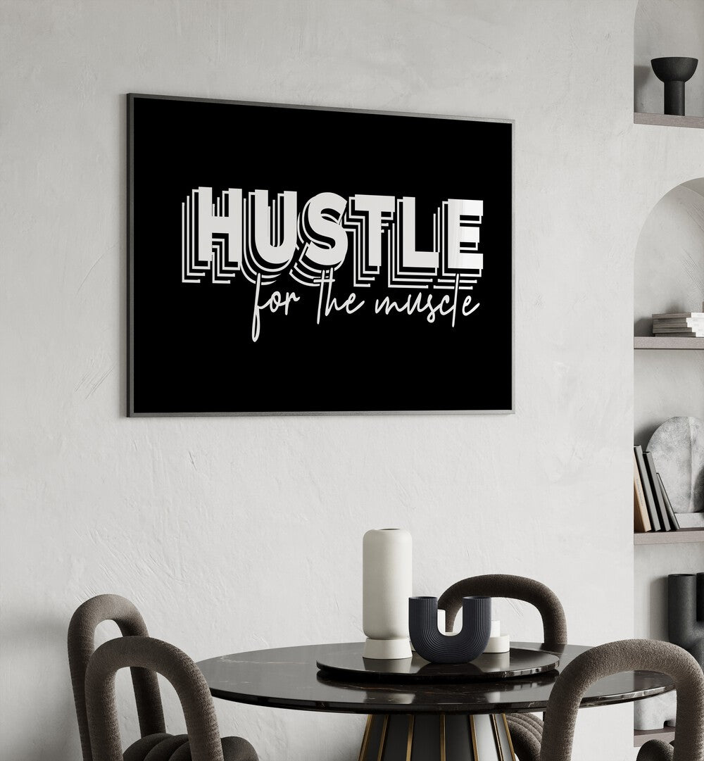 Hustle for the Muscle Quotes and Typography Posters in Black Plain Frame placed on a wall behind a dining table