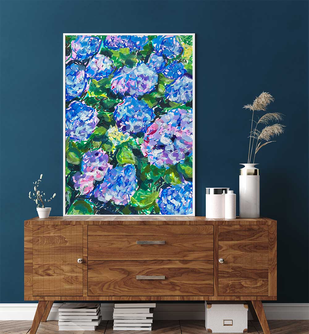 Framed hydrangea artwork in blue-green tones, HYDRANGEAS , FLORAL FLOWER PAINTINGS styled above mid-century console.