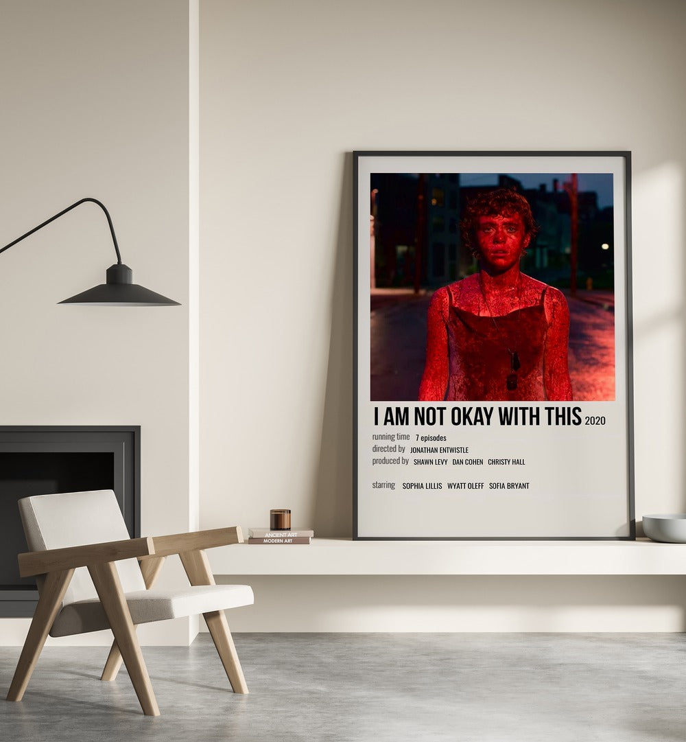 I AM NOT OKAY WITH THIS 2020 MOVIE POSTERS in Black Plain Frame placed on wall beside chair and lamp