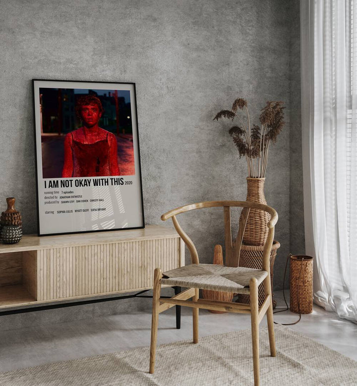 I AM NOT OKAY WITH THIS 2020 MOVIE POSTERS in Black Plain Frame placed on a table beside chair