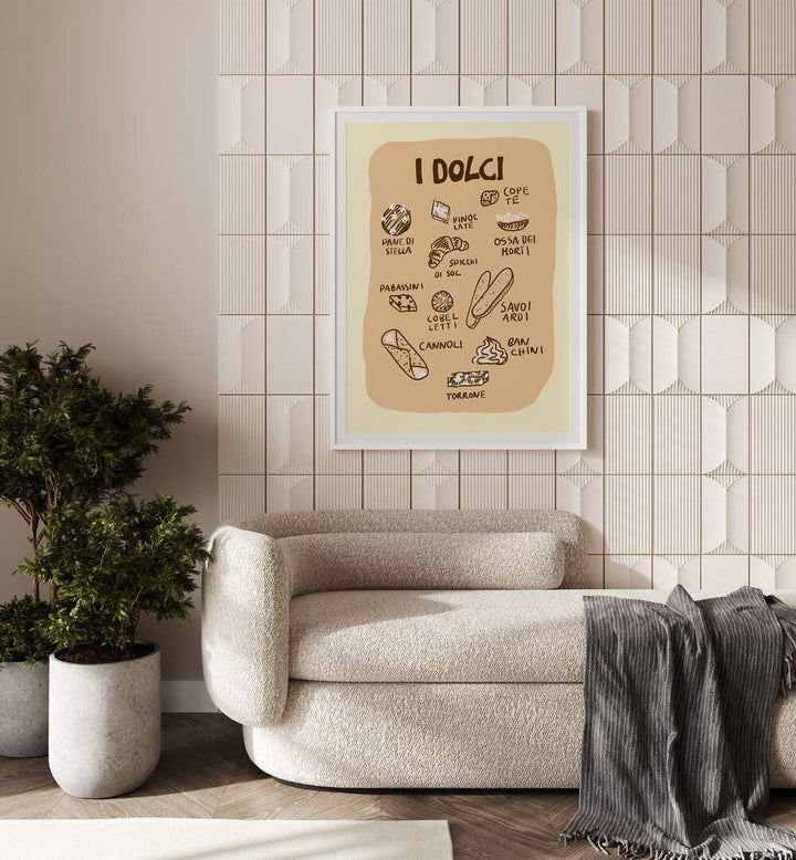 I Dolci by Studio Dolci Kitchen Art Prints in White Plain Frame placed on a wall behind a sofa