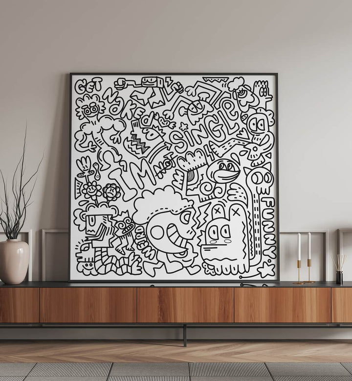 I M Not Single BW Doodle Art Painting in Black Plain Frame it is placed on the stand.