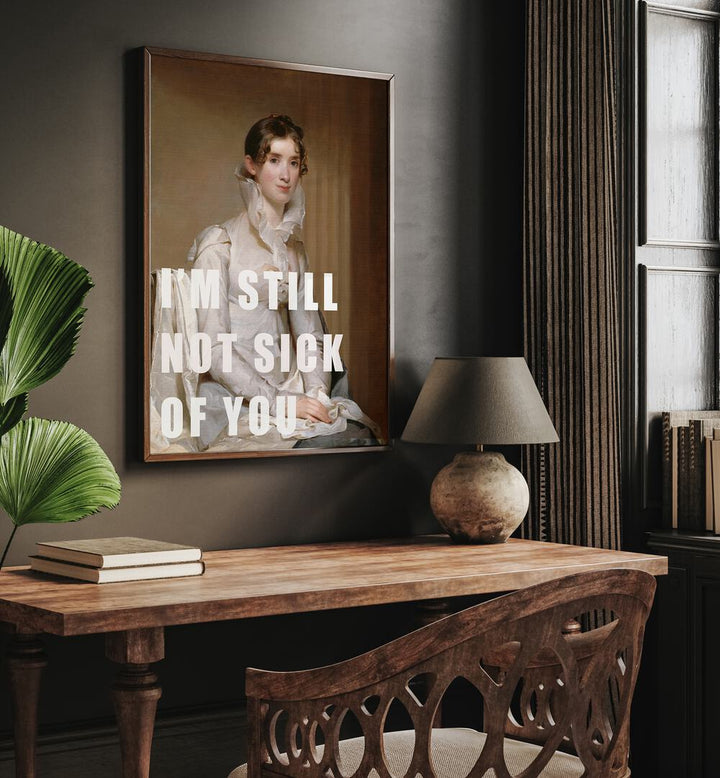 I M Still Not Sick of You by the Art Concept Altered Art Prints in Dark Wood Plain Frame placed on a wall behind a study table