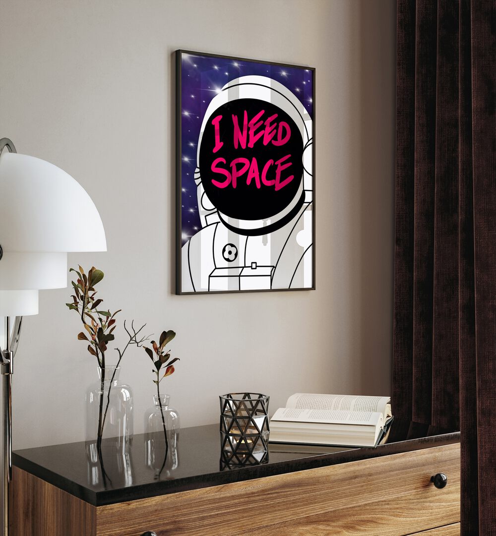 I Need Space Astronaut & Nasa Paintings, Space Art Prints Artwork in Black Plain Frame placed on a Cream Colored Wall placed above a Console Table


