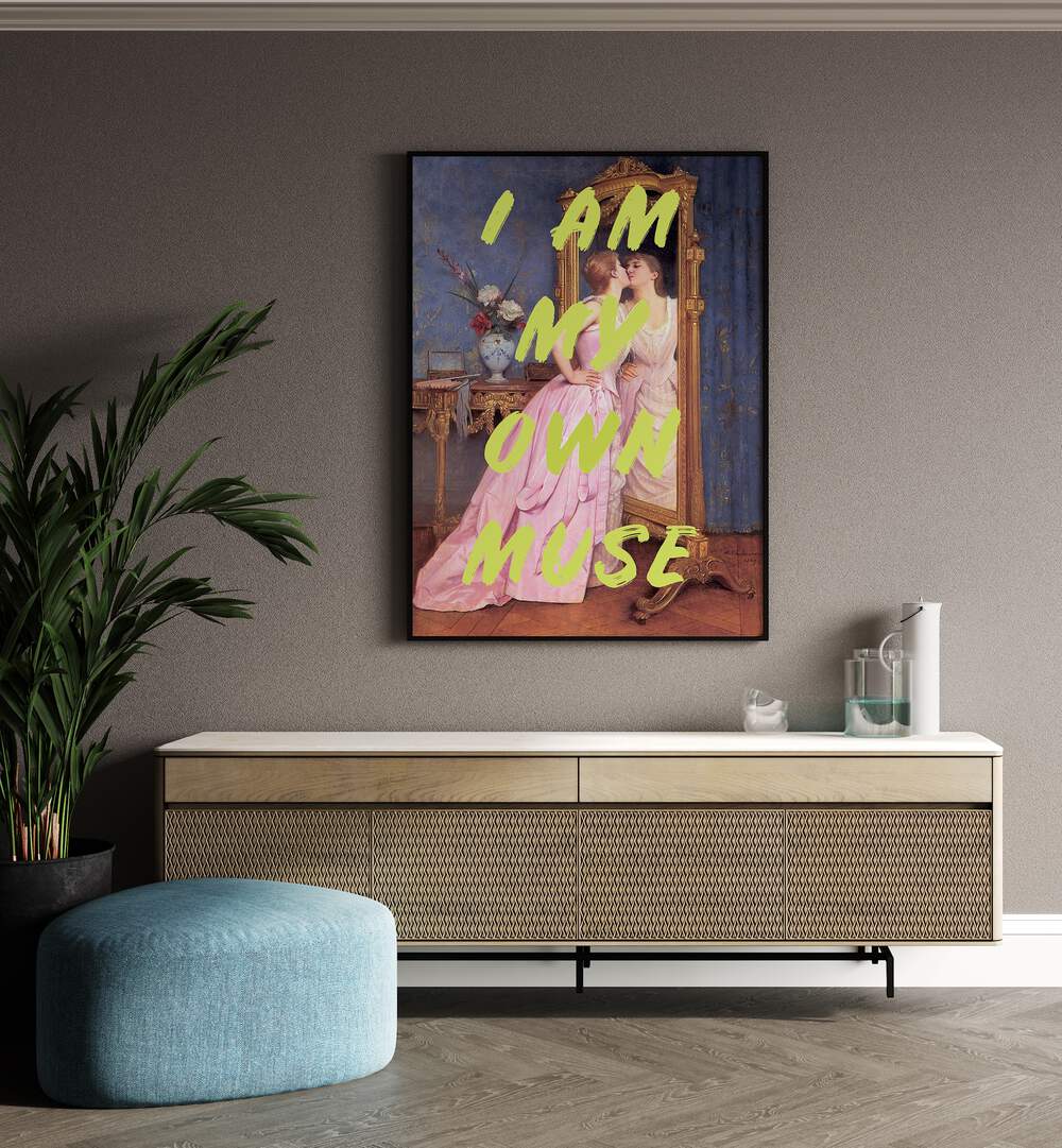 I'm My Own Muse by Grace Digital Art Co Altered Art Prints in Black Plain Frame placed on a wall behind a console table and beside a plant