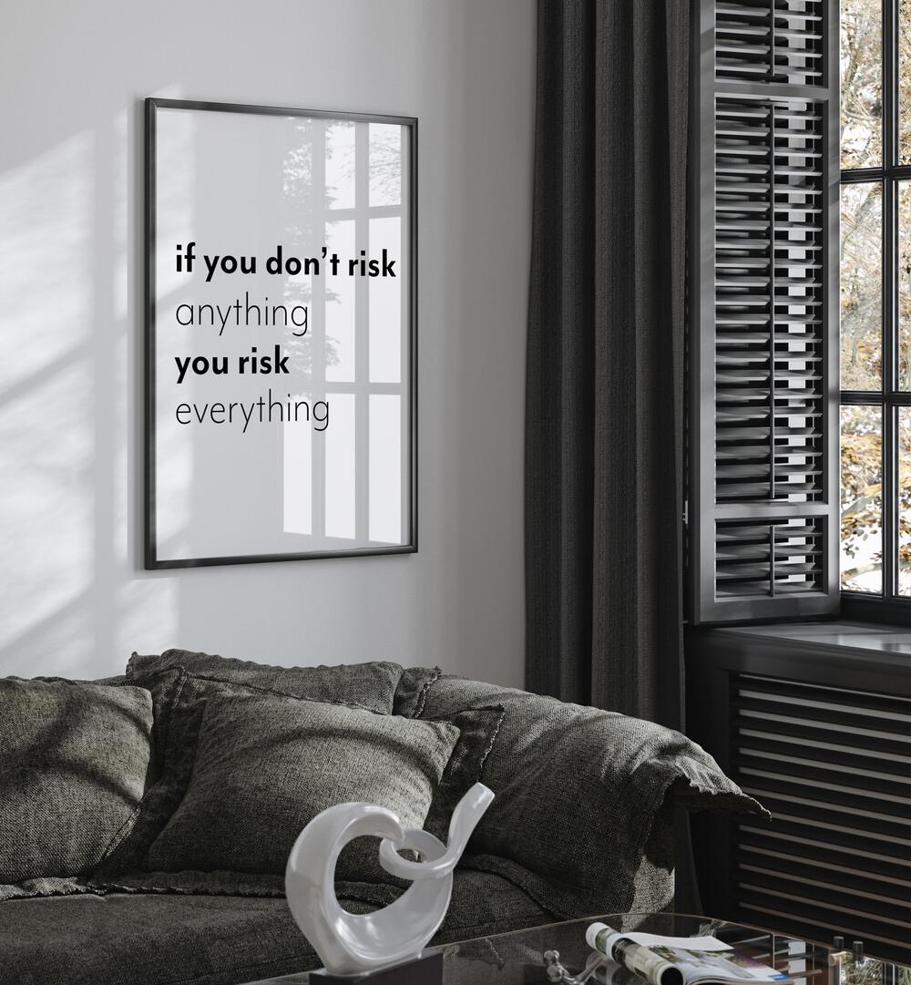 If You Dont Risk  By 1 X Studio Quotes And Typography Posters in Black Plain Frame placed on a White Colored Wall near a Dark Grey Sofa in the Living Room