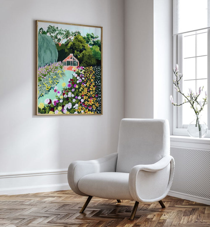 In Bloom By Sarah Gesek Wall Art Prints in Oak Wood Plain Frame placed on a white wall beside a sofa and behind a window