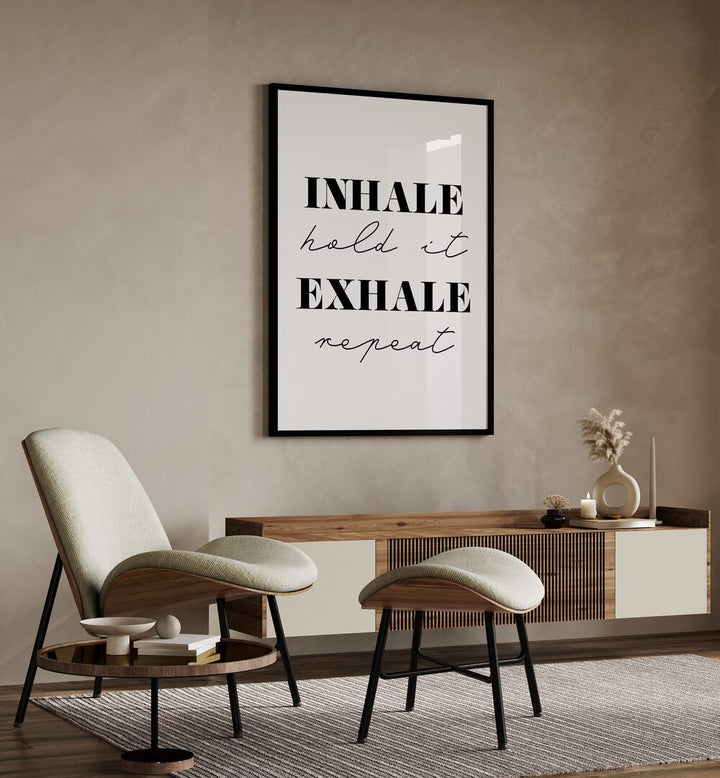 Inhale And Exhale By 1 X Studio Quotes And Typography Posters in Black Plain Frame placed on a Beige Colored Wall above a Console Table in the Drawing Room