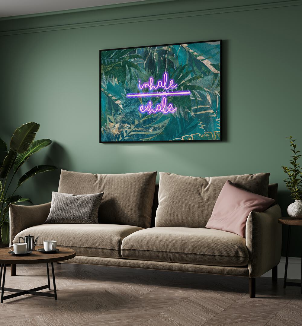 Inhale Exhale By Sarah Manovski Quotes and Typography Poster in Black Plain Frame on a green wall behind a sofa for living room