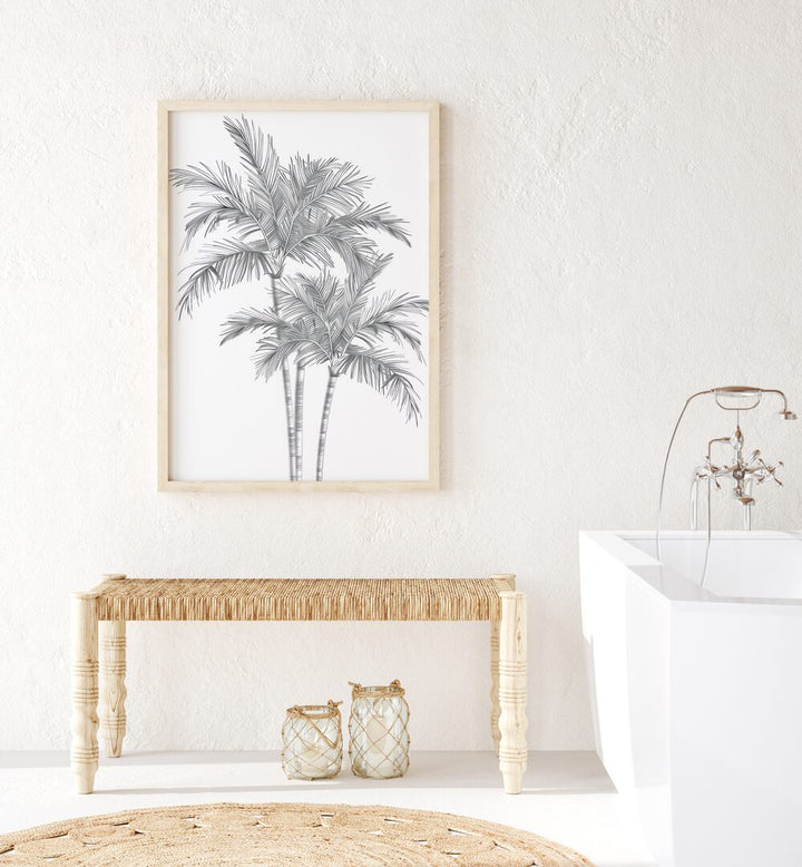 Ink Palm Promenade Beach Prints Coastal Wall Art in Oak Wood Plain Frame placed on a wall beside a table and beside a bathtub for bathroom