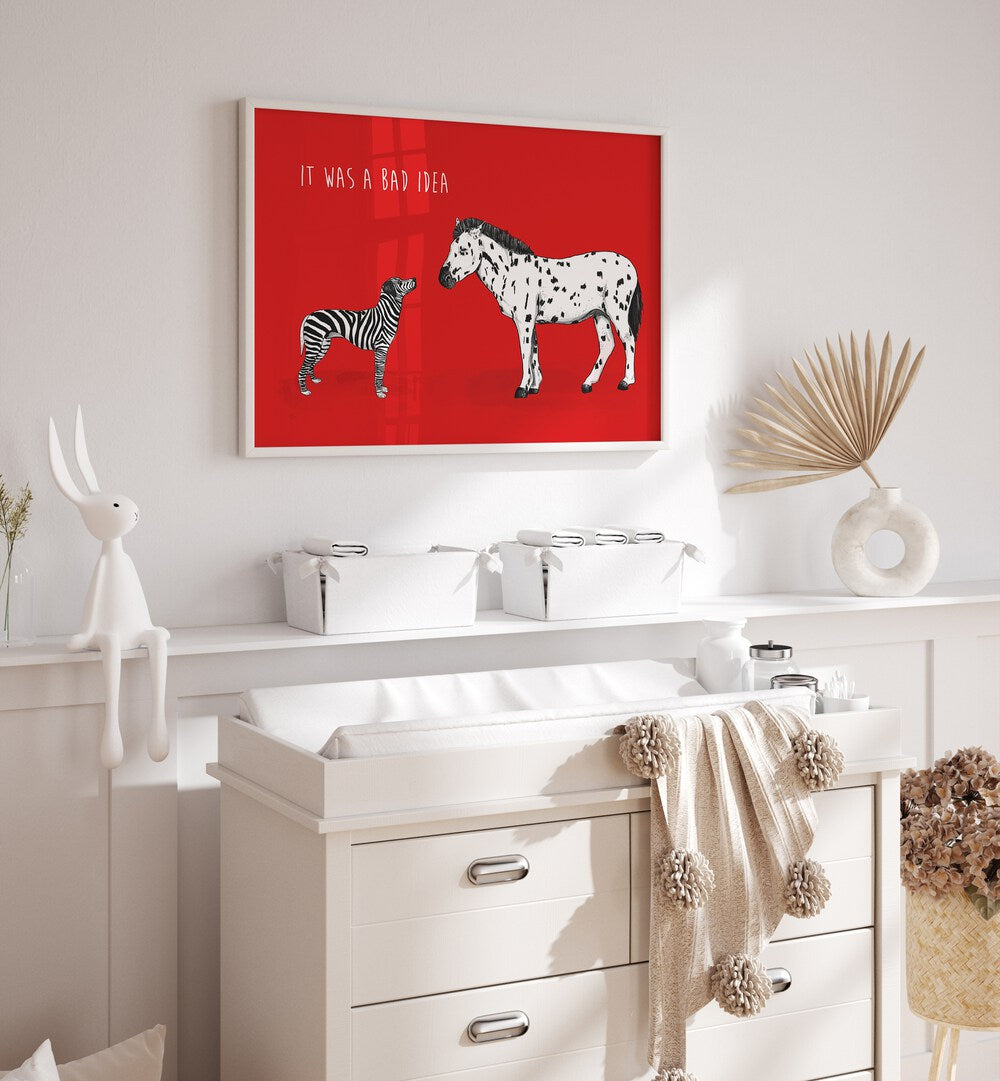 It Was A Bad Idea By Balazs Solti Kids Room Art in White Plain Frame placed on a White Colored Wall above a Console Table in the Drawing Room