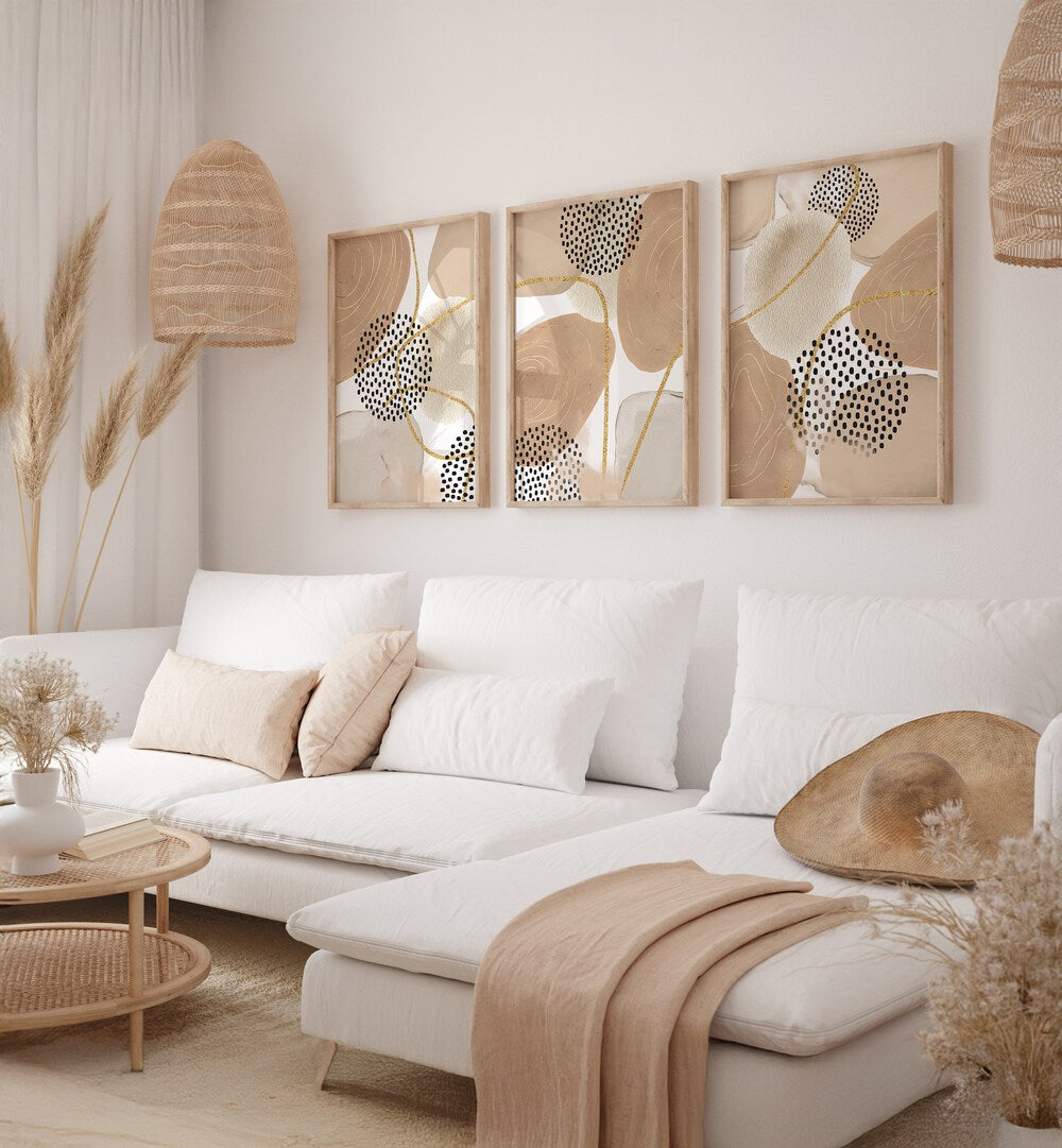 Stylish JEALOUS BEIGE SET, SET OF 3 PAINTINGS enhancing a modern living room with elegance and sophistication.