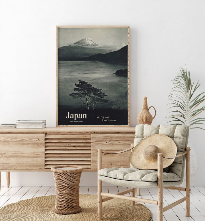 Japan-Mt Fuji  Retro Travel Posters in Oak Wood Plain Frame placed on a console table behind a chair