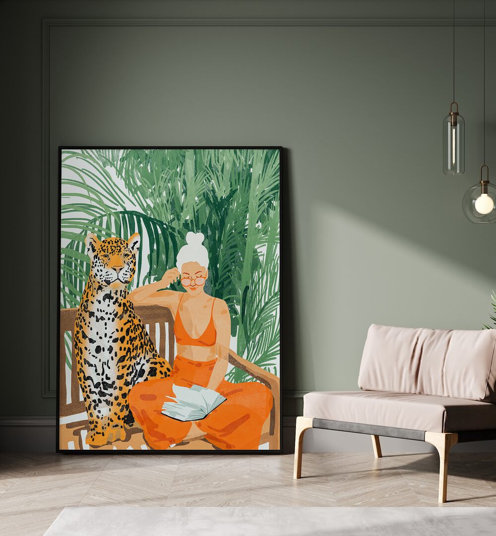 Jungle Vacay II By Uma Gokhale Woman Illustration Paintings in Black Plain Frame on the floor beside a sofa