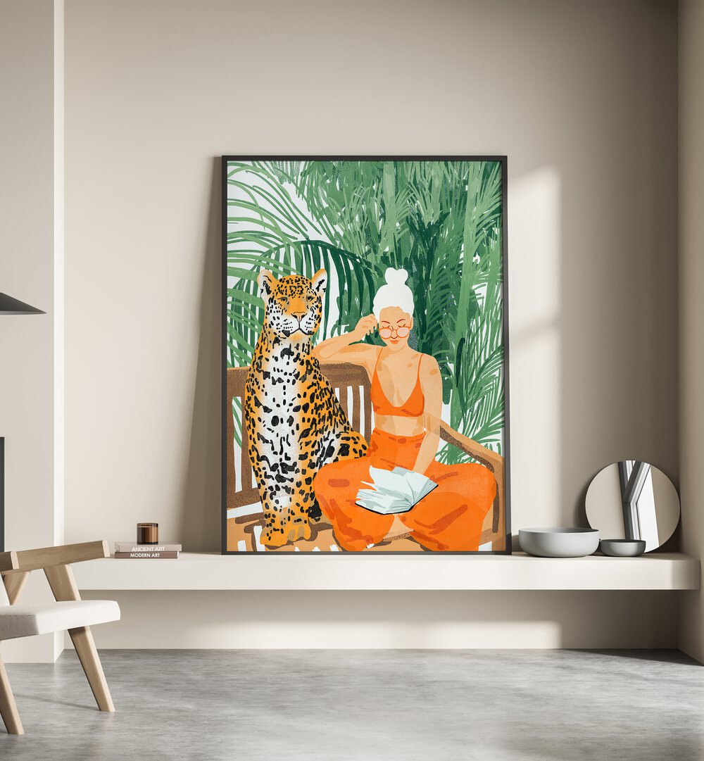 Jungle Vacay II By Uma Gokhale Woman Illustration Paintings in Black Plain Frame on a shelf beside a mirror