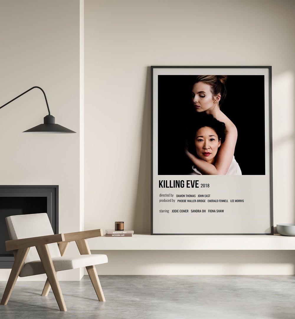 KILLING EVE 2018 MOVIE POSTERS in Black Plain Frame placed on wall beside chair and lamp