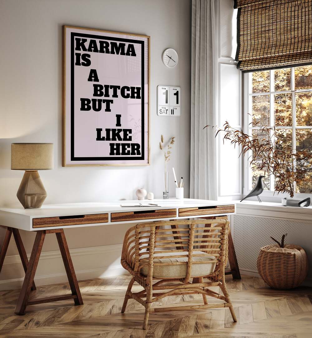 Karma is a Bitch by Athene Fritsch Quotes and Typography Posters in Oak Wood Plain Frame placed on a wall behind a study table and beside a window