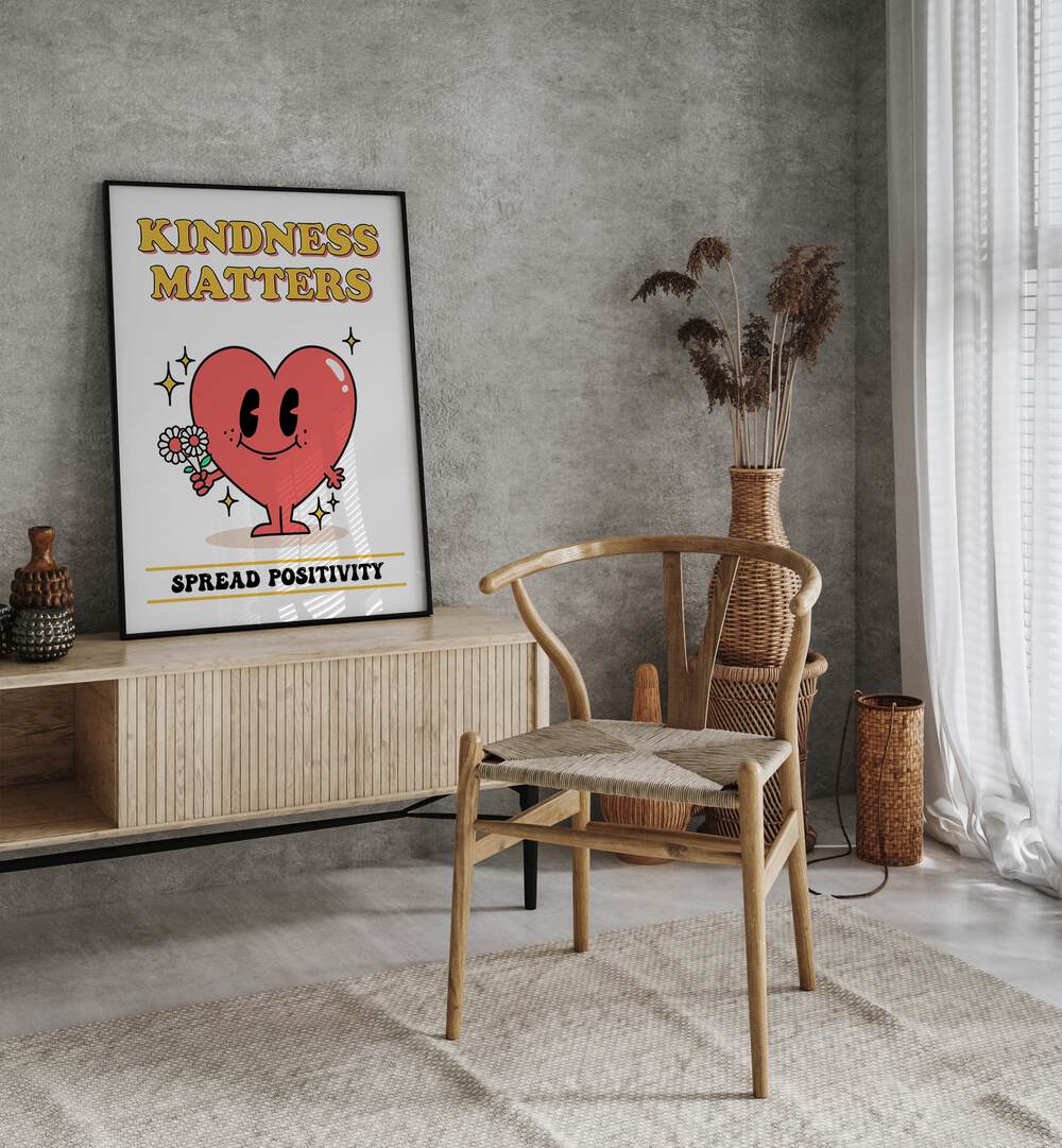 Kindness Matters Quotes and Typography Posters in Black Plain Frame placed on a wall behind a console table beside a chair