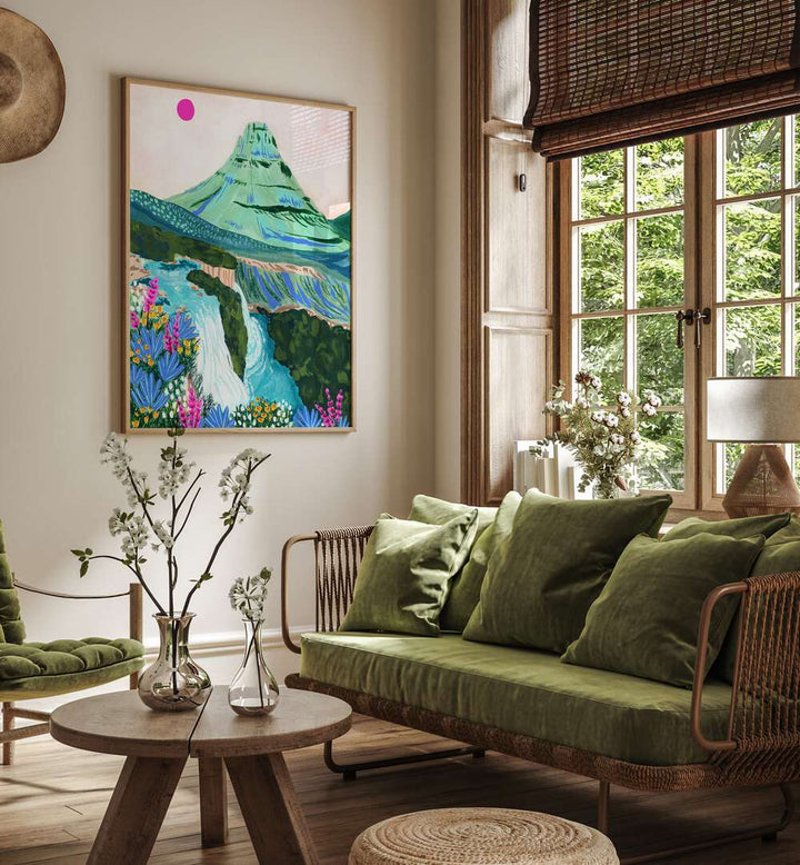 Kirkjufell By Sarah Gesek Landscape Art Prints in Oak Wood Plain Frame placed on a living room wall beside a window and a sofa