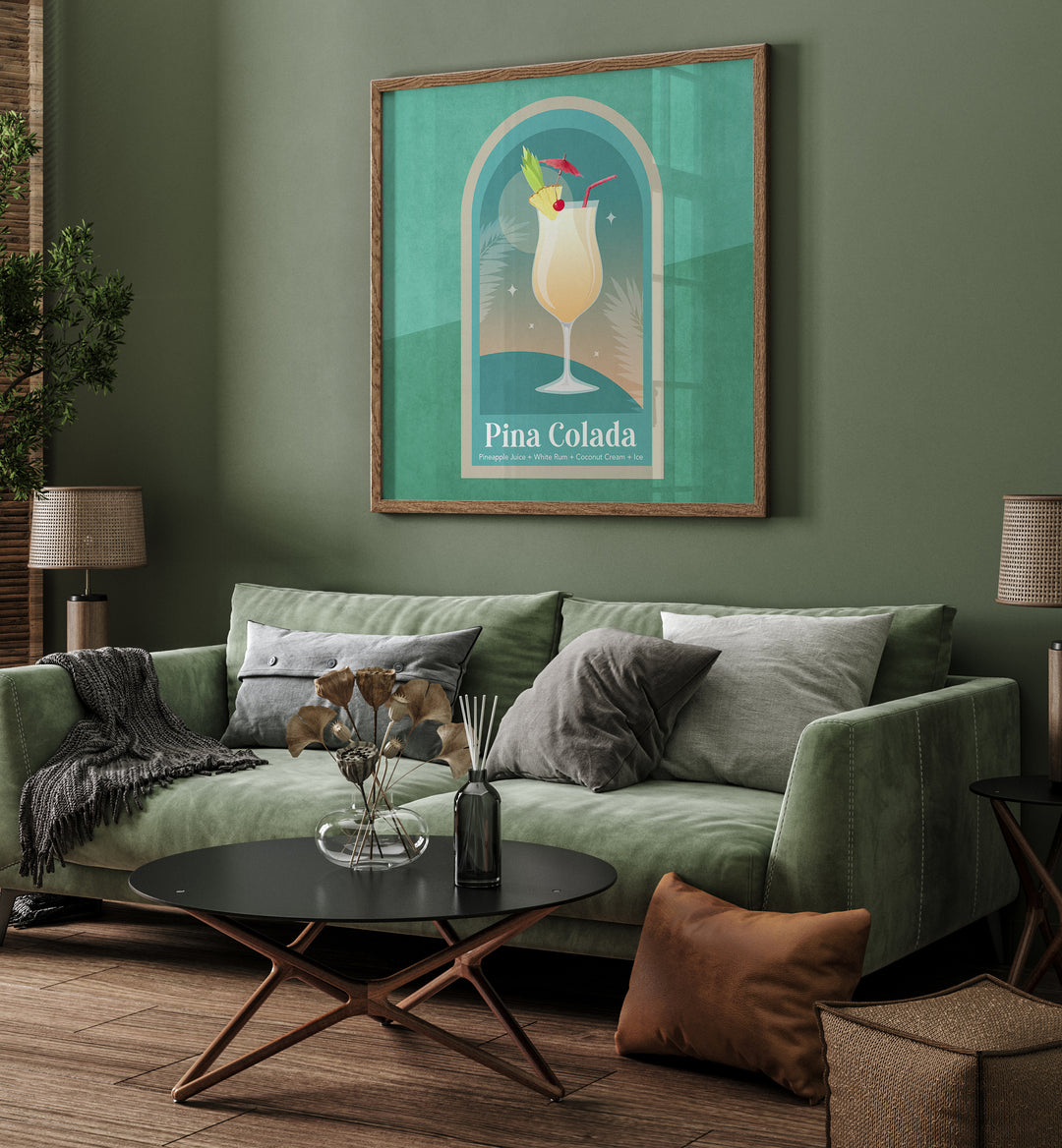 Kokteyl Pina Colada By Emel Tunaboylu Bar Posters Bar Art Prints in Oak Wood Plain Frame placed on a Green Colored Wall near a Green Sofa in the Living Room