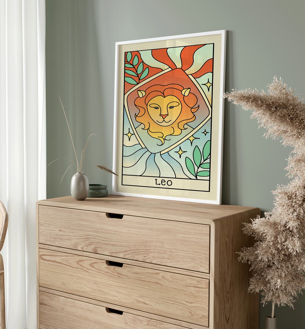 Leo Zodiac & Tarot Art Painting Artwork in plain white frame above console table beside a plant