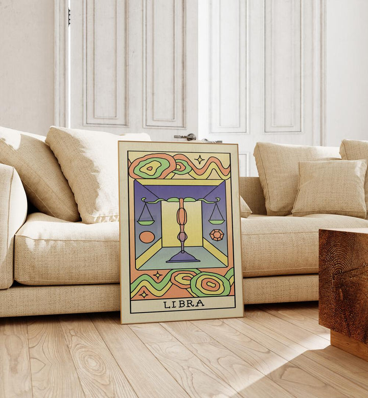 Libra Zodiac & Tarot Art Painting Artwork in plain oakwood frame beside a sofa