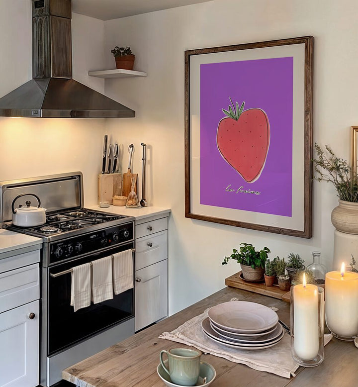 La Fraise by Uplus Me Studio Kitchen Art Prints Kitchen Posters in Dark Wood Frame With Mount placed on a wall in kitchen area between a stove and a dinning table