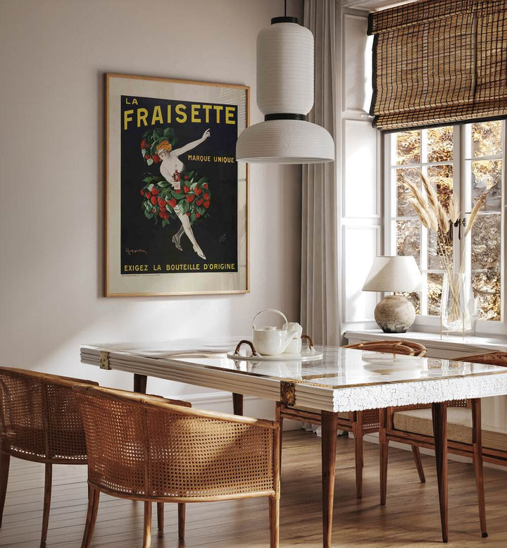 La Fraisette Cafe Art Prints Cafe Posters in Oak Wood Plain Frame placed on a wall in a dining room area beside a window and behind a dining table