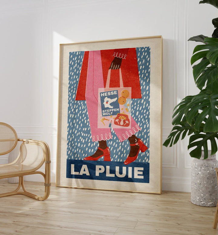 La Pluie French Style By Julia Leister Wall Art Prints in Oak Wood Plain Frame on a wooden floor beside a chair