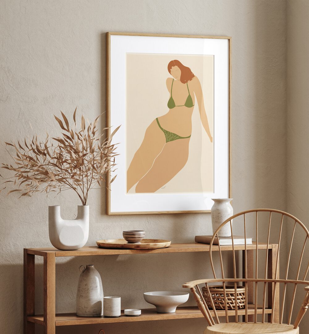 Lady Seashore By Andi Bell Beach Prints in Oak Wood Frame With Mount on a cream wall placed above a table