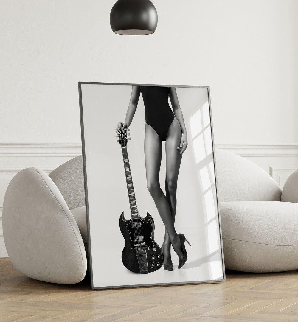 Lady With the Gibson by David Drake Fine Art Photography Fashion Photography in Black Plain Frame placed on the floor beside a sofa