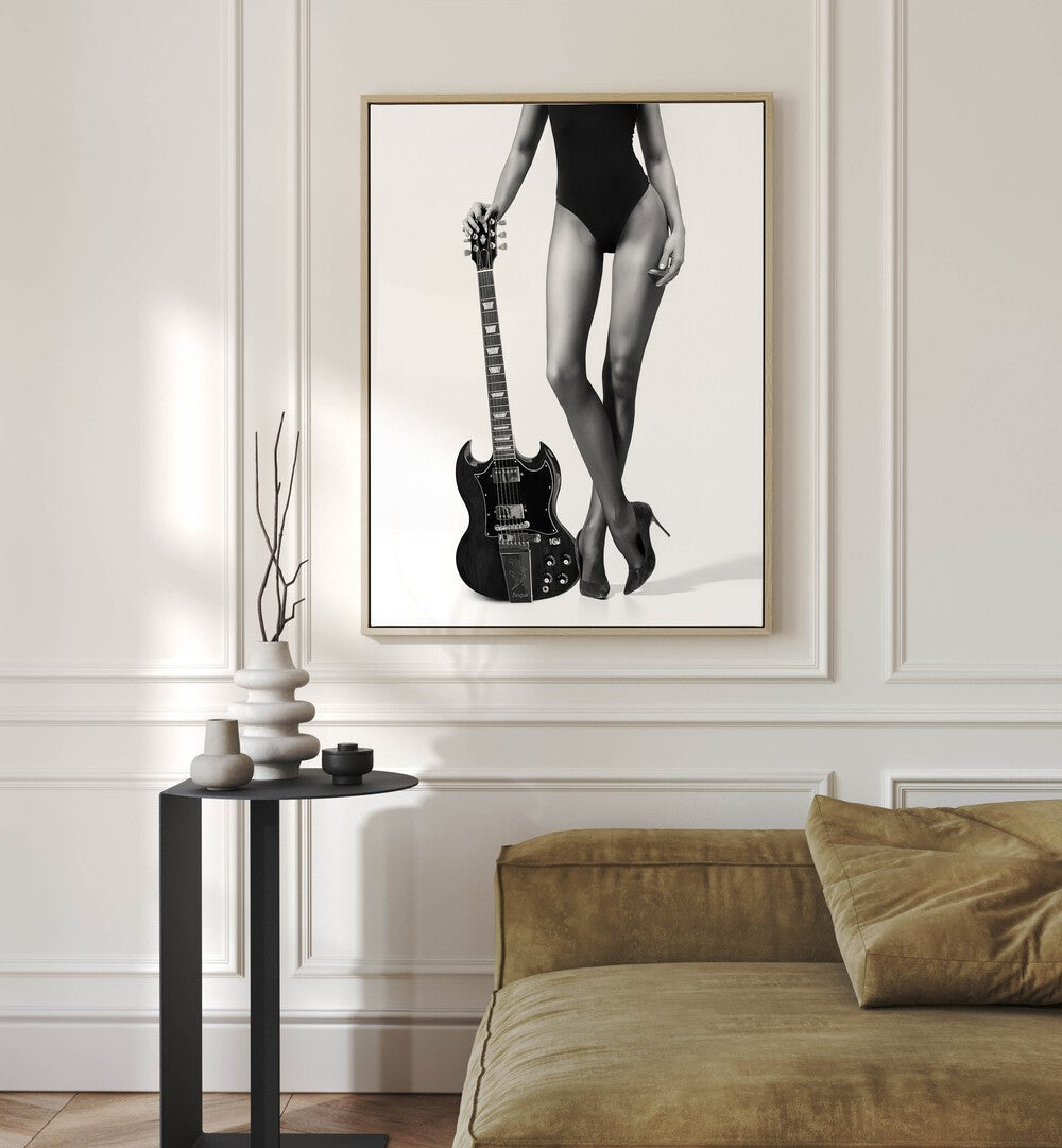 Lady With the Gibson by David Drake Fine Art Photography Fashion Photography in Oak Wood Floater Frame placed on a wall behind a sofa