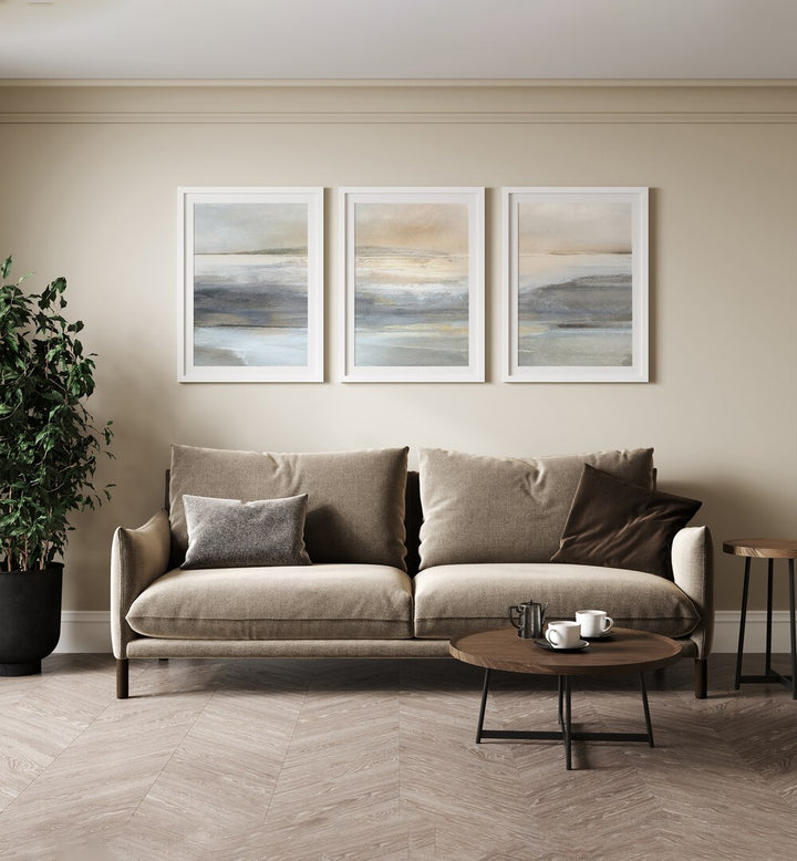 Landscape Abstraction Set Set Of 3 Paintings in White Frame With Mount placed on a living room wall behind a brown sofa and beside a plant