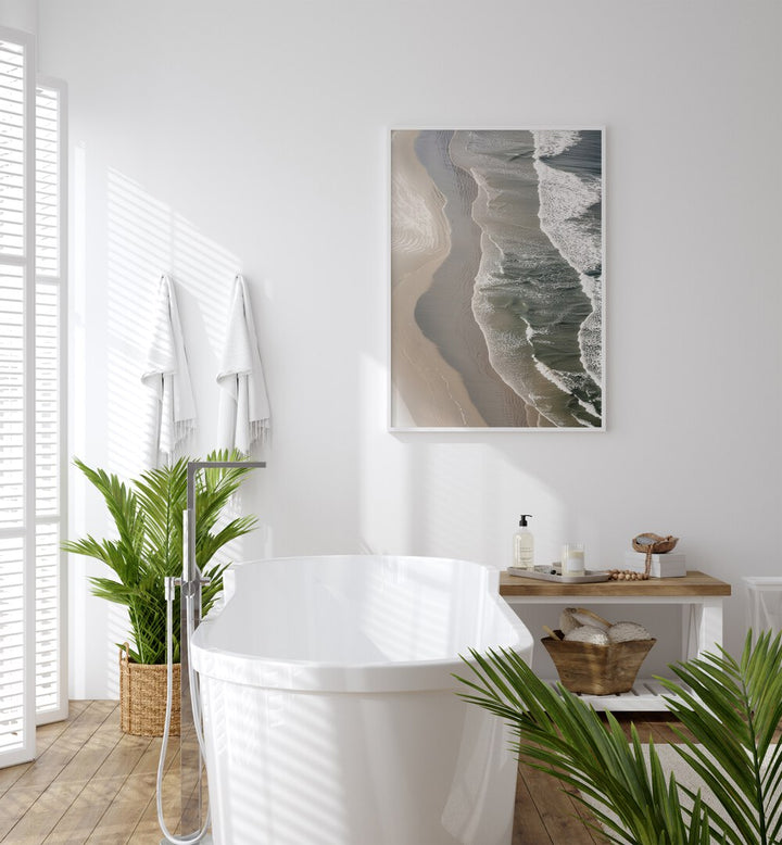 Layered Horizons Beach Prints Coastal Wall Art in White Plain Frame placed on a wall behind bathtub for bathroom