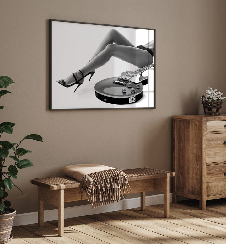 Leggy Les Paul by David Drake Fine Art Photography Fashion Photography in Black Plain Frame placed on a beige wall behind a table